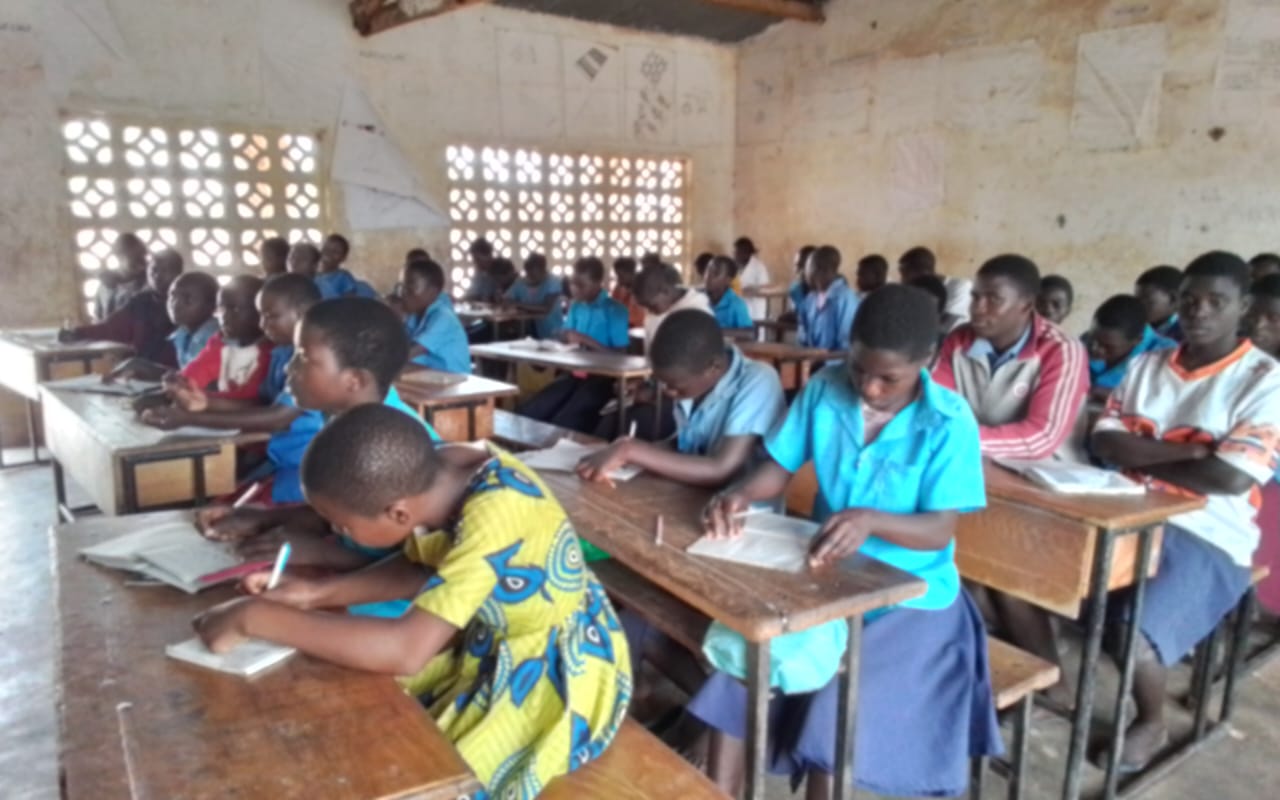 Learners working at wooden desks inside a Chipata Primary School classroom