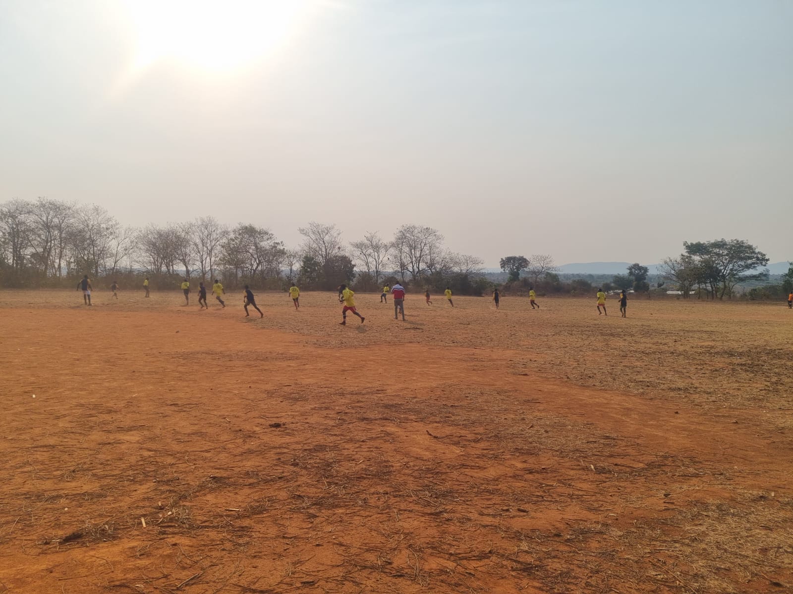 A sponsored football match taking place on the Katosa community field