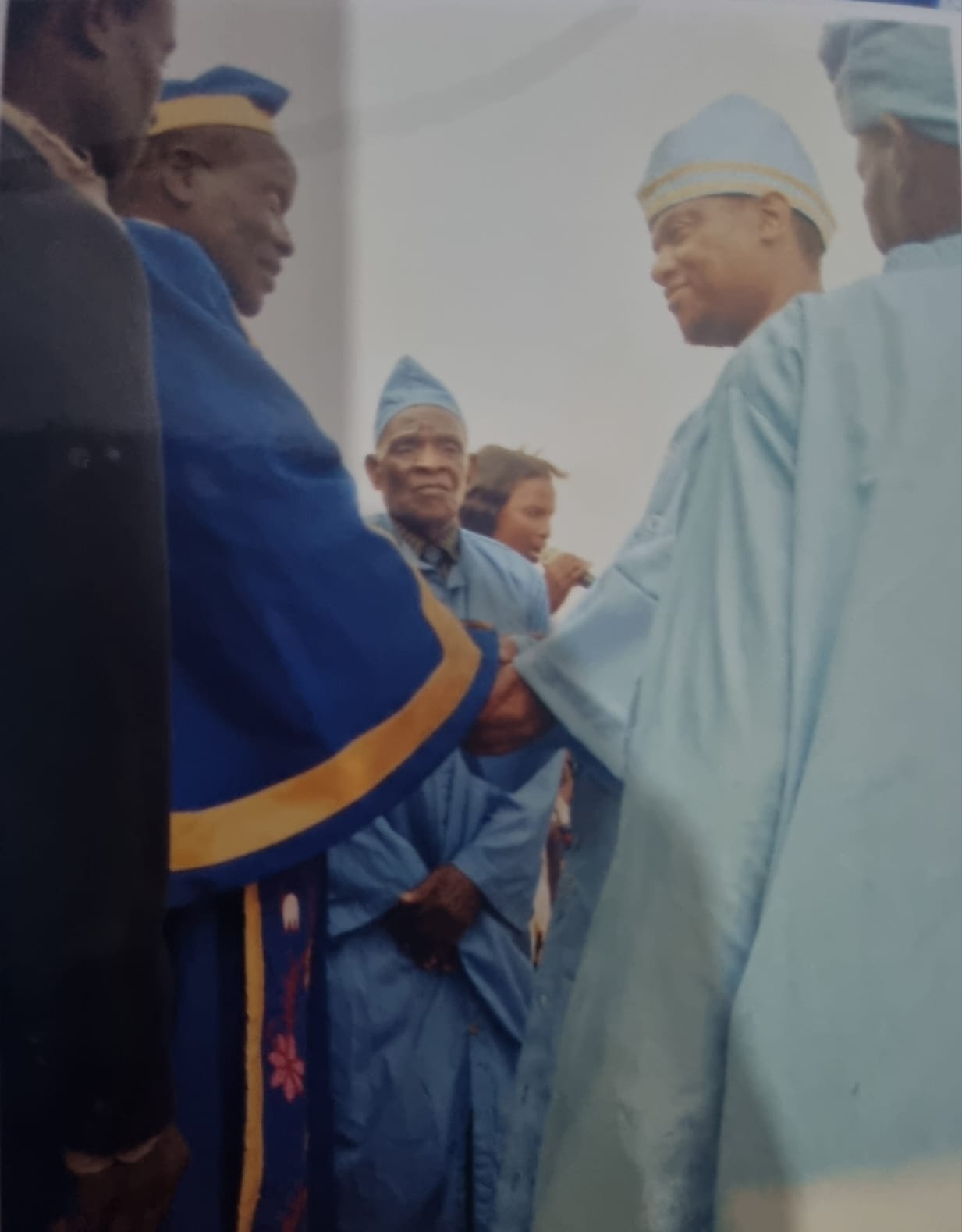 Group Village Head Katosa shaking hands with T/A Kaluluma while both wear chiefly robes